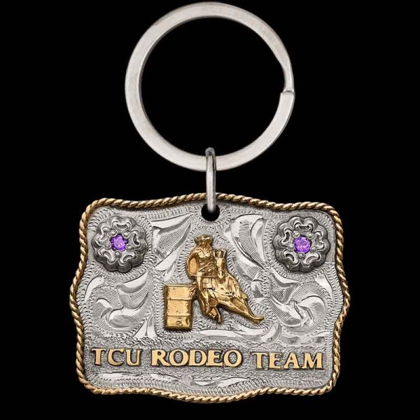 "Our Longest Ride Custom Keychain is a mini buckle designed with the same craftsmanship as our signature buckles. Crafted on a hand-engraved German Silver base, it features two flowers in the top corners, accented with cubic zirconia stones. The desi